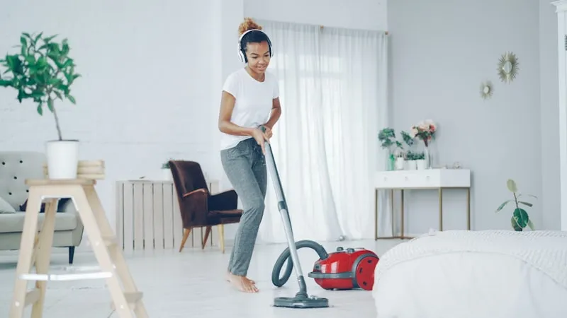 Friendly TimeBack cleaner vacuuming a bright, modern home in Milton Keynes